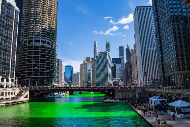 Cloud formation of a smile above the crowds gathered around a green dyed Chicago River on St. Patrick's Day